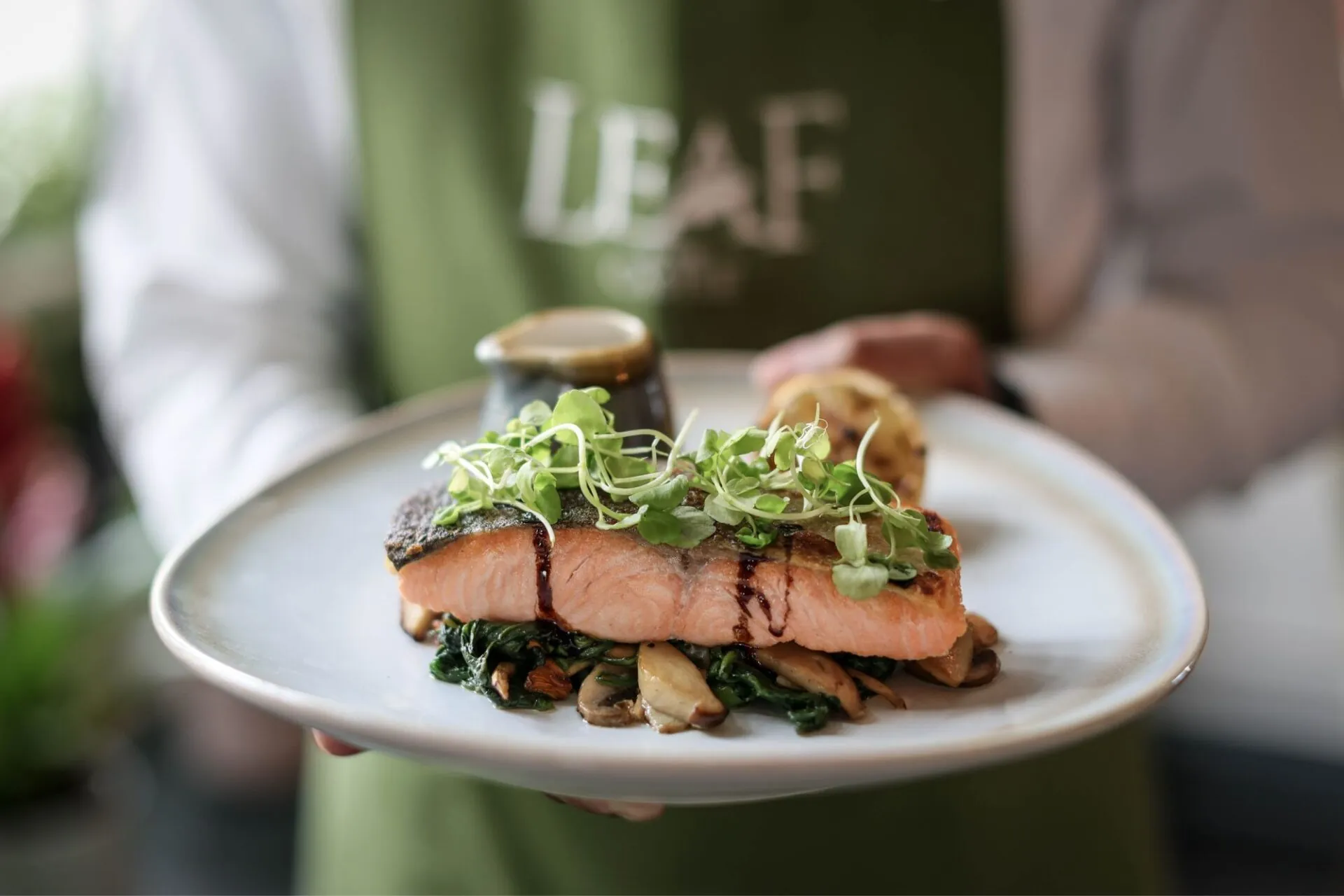 The Castle Hotel Windsor waiter serving seared Scottish salmon