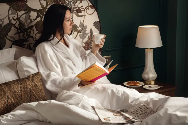 Francis Hotel Bath model reading in bed