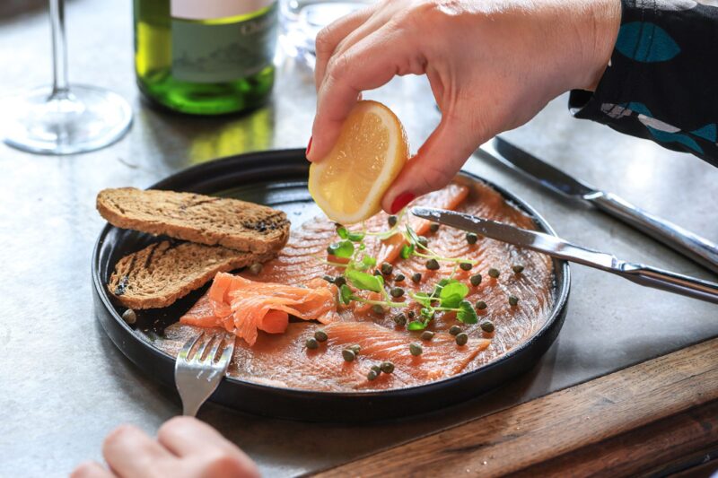 The Castle Hotel Windsor squeezing lemon over Severn & Wye smoked salmon